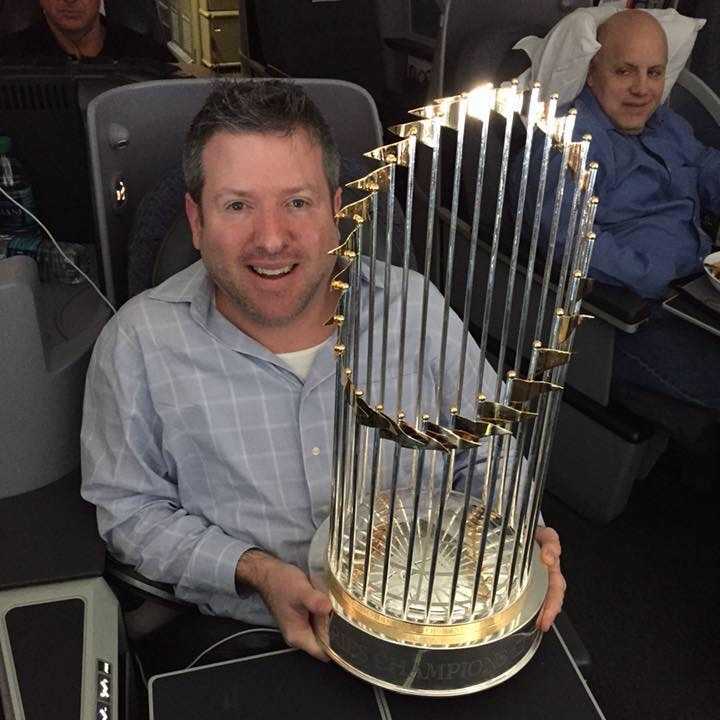 Holding trophy on lap